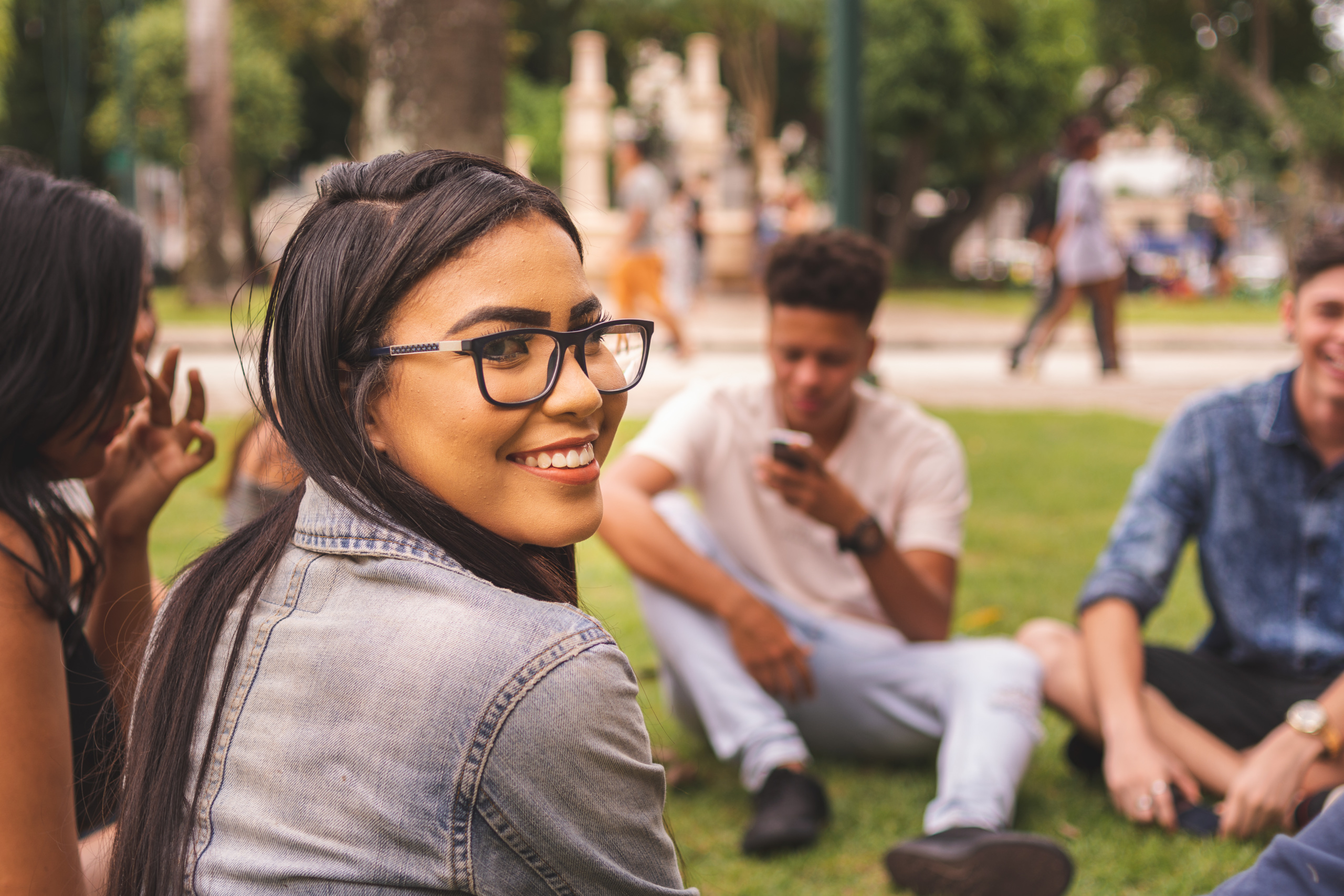 Young brazilian woman enjoying time with her friends at a public park